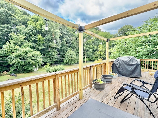 wooden deck featuring area for grilling