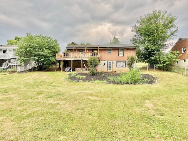 back of house with a wooden deck and a yard