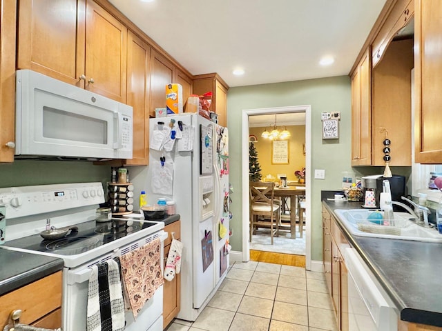 kitchen featuring a chandelier, light tile patterned floors, white appliances, and sink