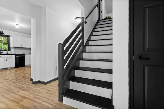 stairs with hardwood / wood-style floors