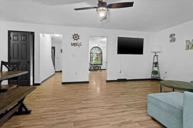 living room featuring ceiling fan and light hardwood / wood-style floors