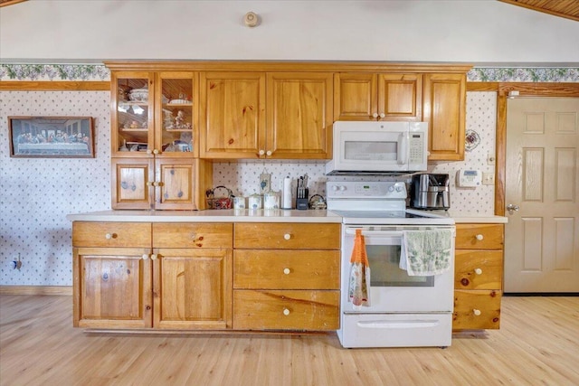 kitchen featuring white appliances and light hardwood / wood-style flooring