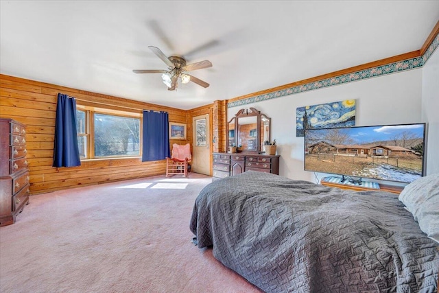 bedroom featuring ceiling fan, wooden walls, and carpet flooring