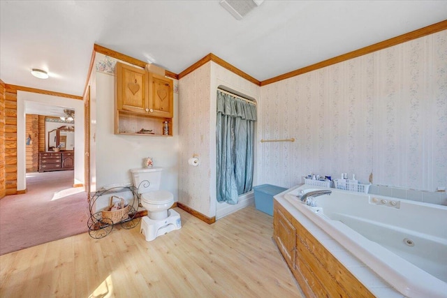 bathroom featuring ornamental molding, toilet, and hardwood / wood-style floors