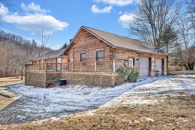 view of snow covered exterior with a deck