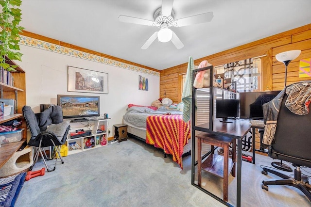 carpeted bedroom with ceiling fan and wooden walls