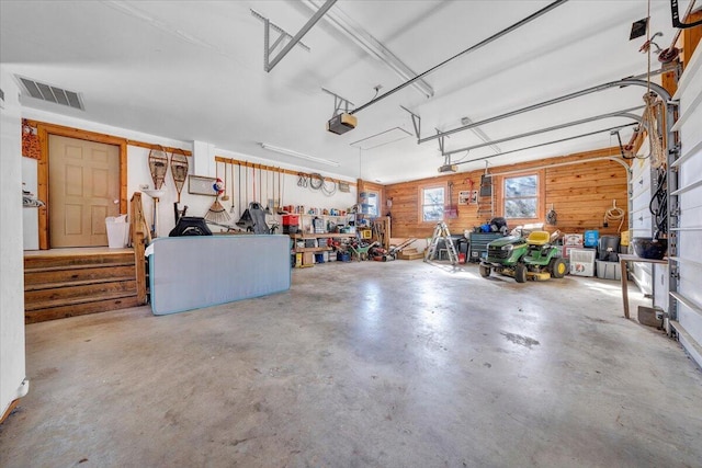 garage with a garage door opener and a workshop area