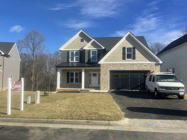 view of front facade with a front yard and a garage