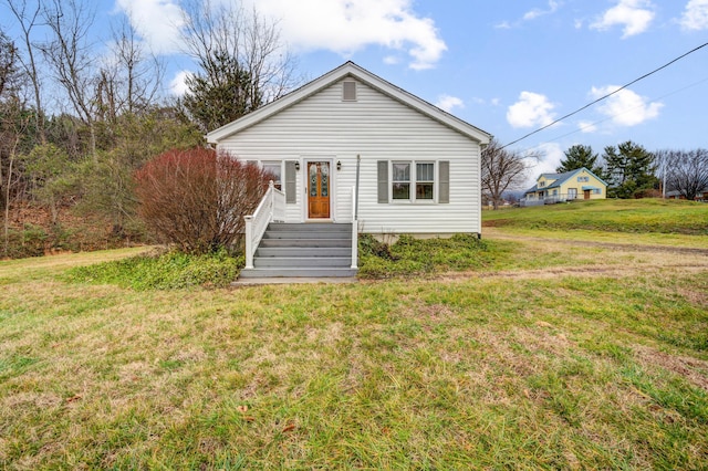 back of house with a lawn