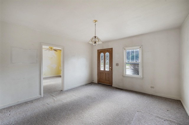 carpeted foyer featuring ceiling fan