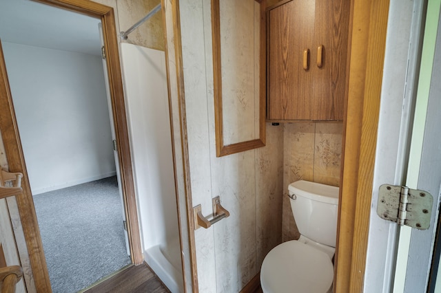 bathroom with baseboards and toilet