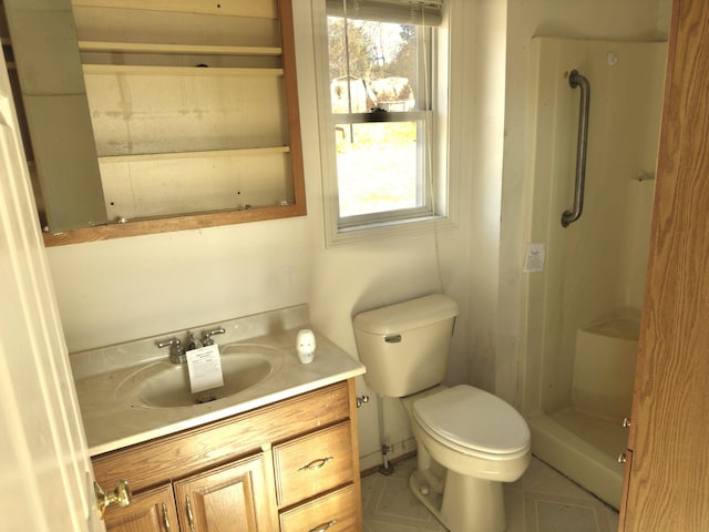 bathroom with vanity, a wealth of natural light, tile patterned floors, and toilet