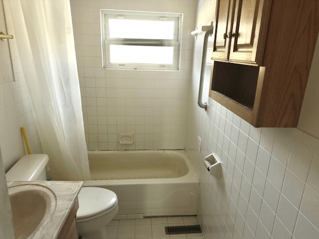 full bathroom featuring tile walls, shower / tub combo, vanity, tile patterned floors, and toilet