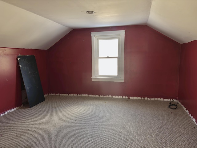 bonus room featuring carpet flooring and vaulted ceiling