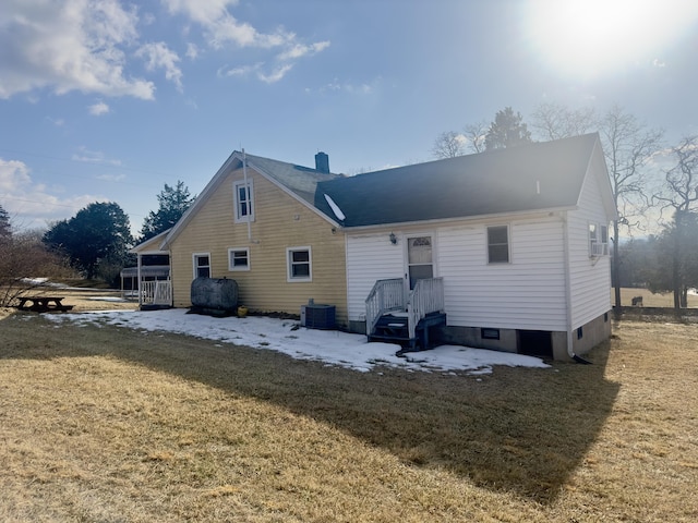 back of house featuring a yard and central AC unit