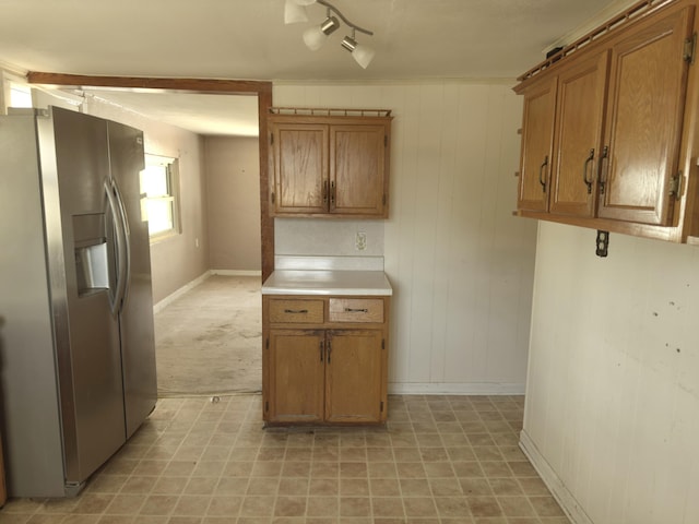 kitchen featuring light carpet, track lighting, and stainless steel fridge