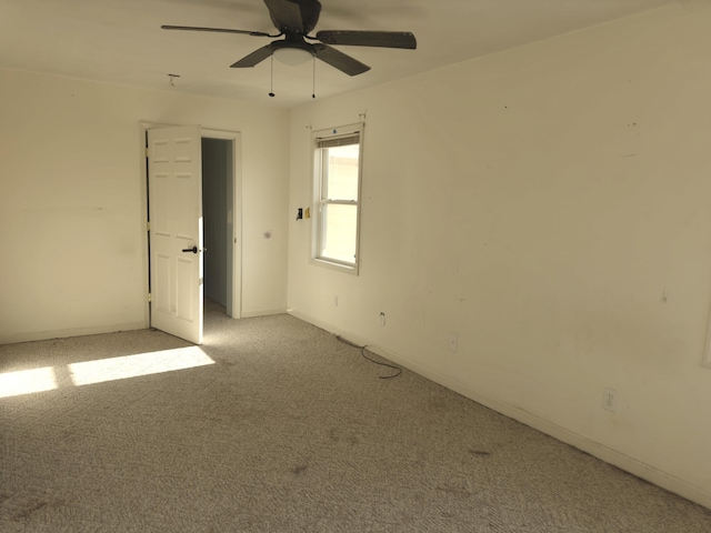 spare room featuring light carpet and ceiling fan