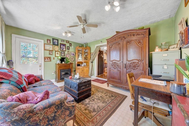 living room with a textured ceiling and ceiling fan