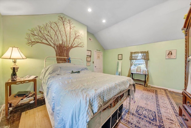 bedroom featuring hardwood / wood-style flooring and vaulted ceiling