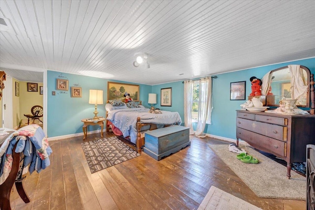 bedroom with dark wood-type flooring