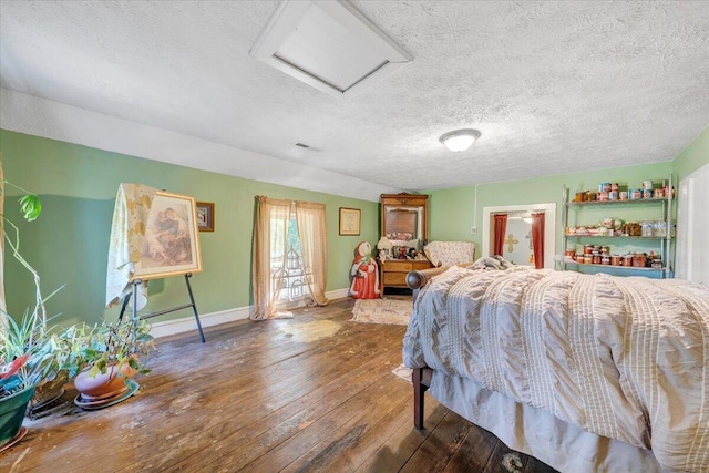 bedroom featuring hardwood / wood-style floors and a textured ceiling