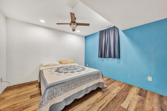 bedroom with hardwood / wood-style floors and ceiling fan