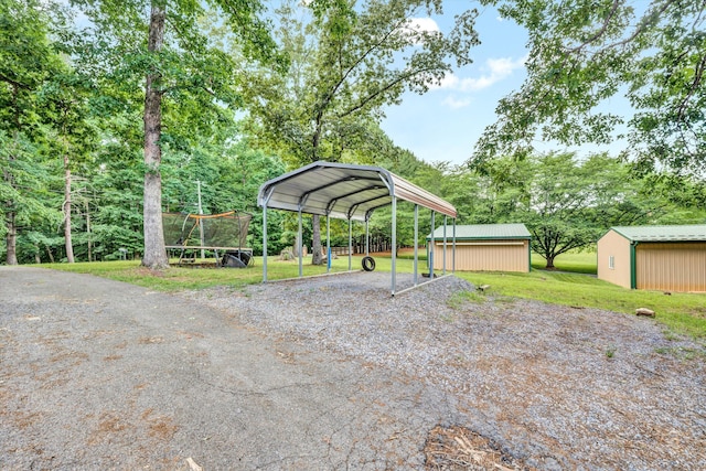 view of parking / parking lot with a lawn and a carport