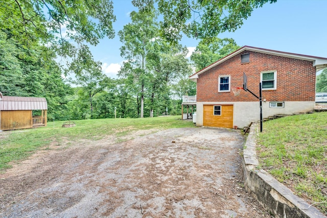 exterior space with a lawn, a shed, and a wooden deck