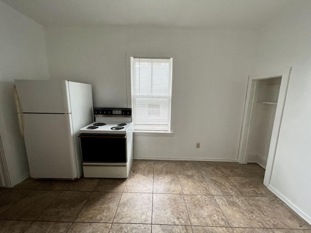 kitchen with light tile patterned floors and white appliances