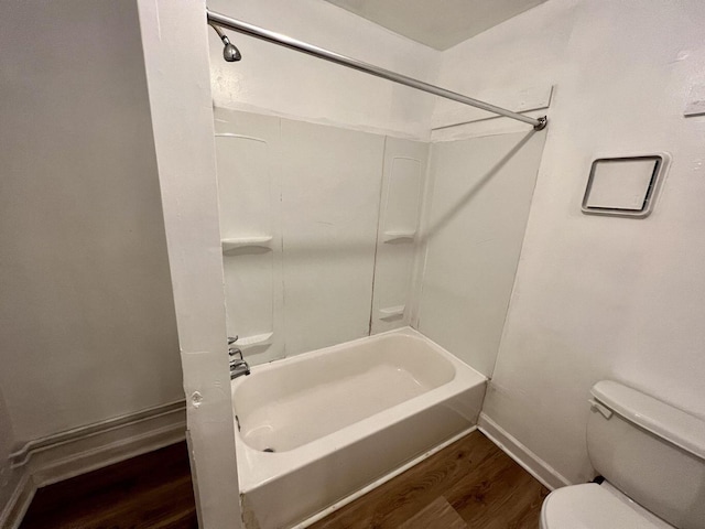 bathroom with toilet,  shower combination, and hardwood / wood-style flooring