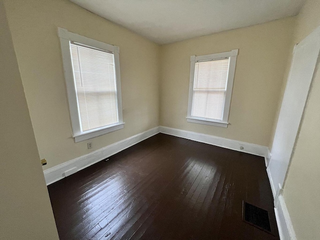 spare room featuring dark hardwood / wood-style floors