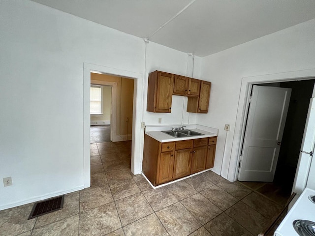 kitchen with sink, white refrigerator, and range