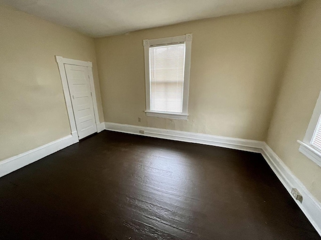 spare room featuring dark hardwood / wood-style floors