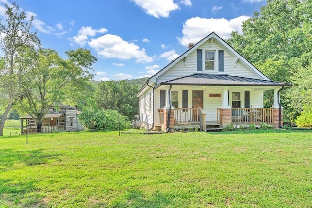 view of front of house featuring a front yard and covered porch