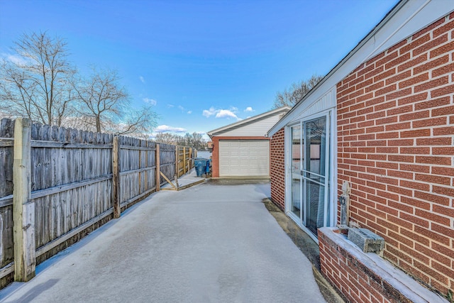 view of patio / terrace with a garage and an outdoor structure