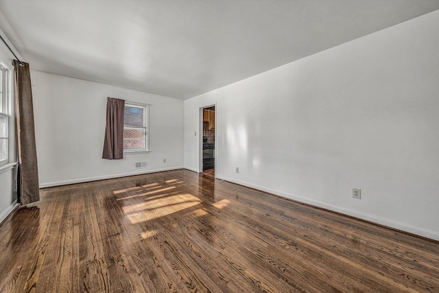 spare room with dark hardwood / wood-style flooring