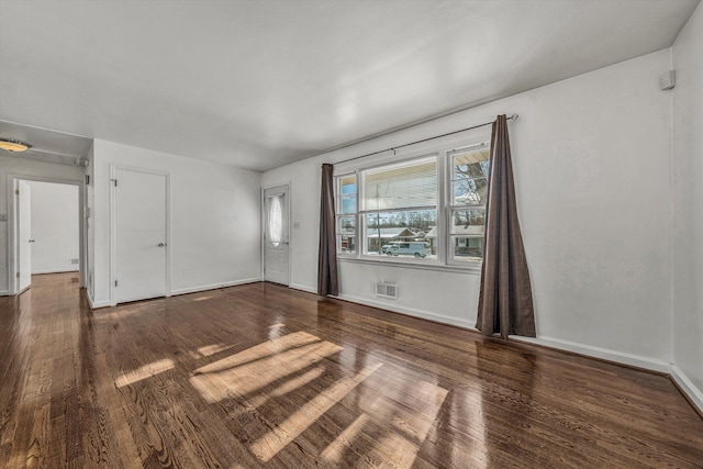 unfurnished room with dark hardwood / wood-style flooring