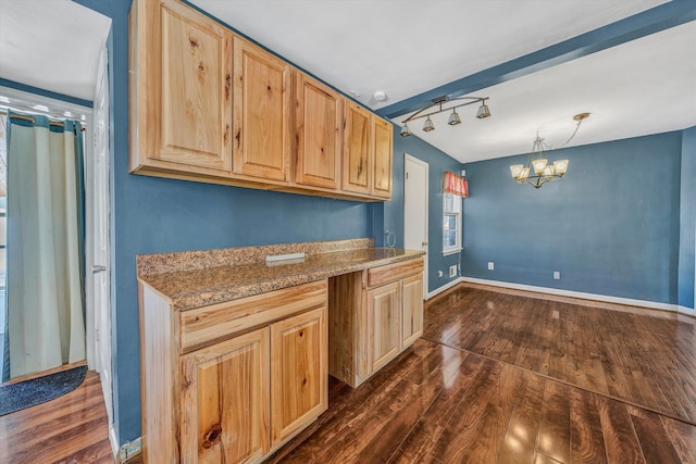 kitchen featuring light brown cabinetry, decorative light fixtures, stone countertops, a chandelier, and dark hardwood / wood-style floors