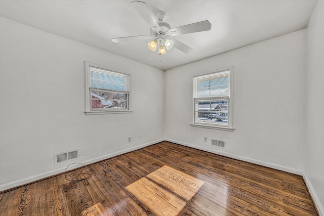 spare room featuring dark hardwood / wood-style flooring and ceiling fan