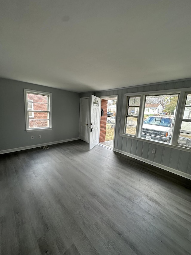 unfurnished living room with dark hardwood / wood-style floors