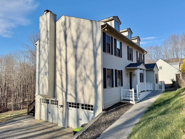 view of property exterior featuring central AC unit and a garage