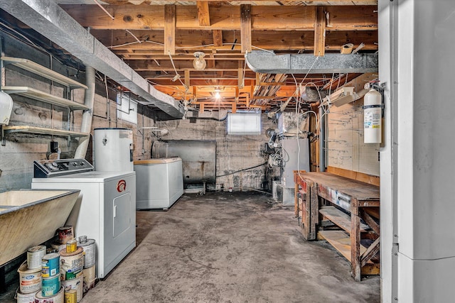 basement with washing machine and dryer and water heater