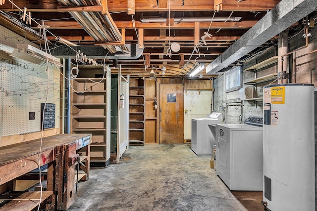 basement featuring a workshop area, washer and clothes dryer, and water heater