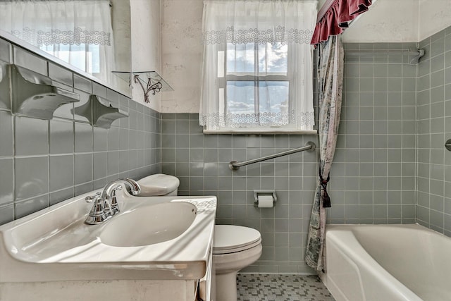 full bathroom featuring vanity, tile patterned floors, shower / bath combination with curtain, toilet, and tile walls