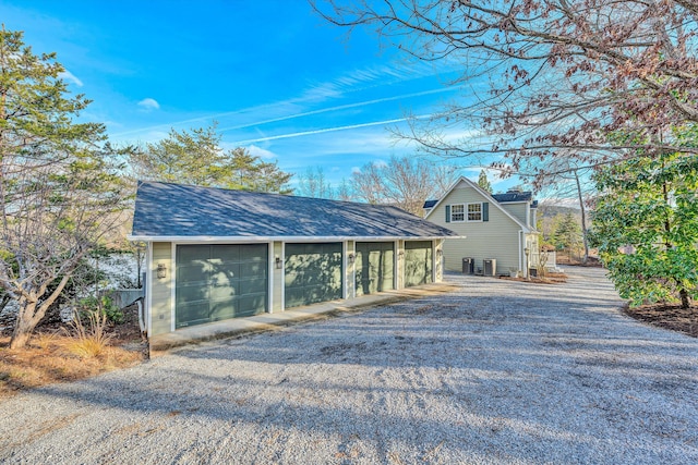 exterior space with a garage and an outbuilding