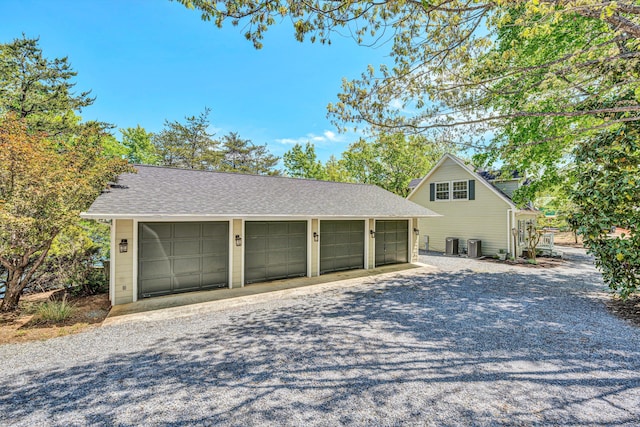 detached garage featuring central AC unit