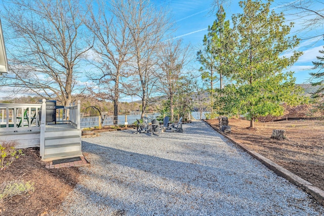 view of yard with a deck with water view