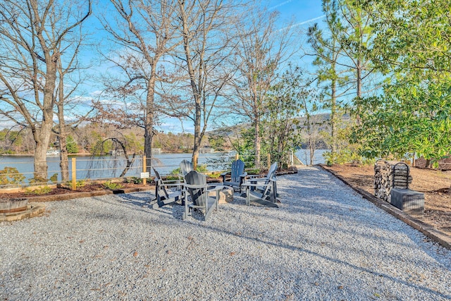 view of yard with a water view and a fire pit