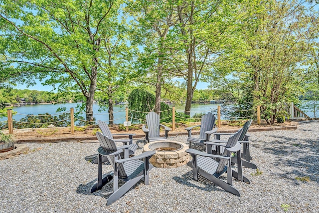 view of yard with an outdoor fire pit and a water view