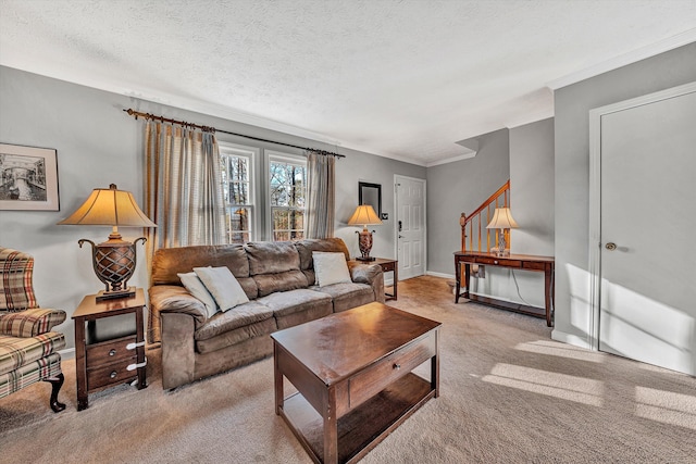 carpeted living room with ornamental molding, a textured ceiling, and baseboards
